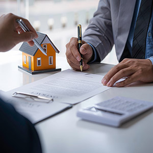 Discussion with a real estate agent, House model with agent and customer discussing for the contract to buy, get insurance or loan real estate or property.